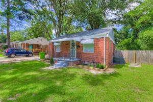 a brick house in a yard with a fence at Updated Columbian Cottage in Columbia