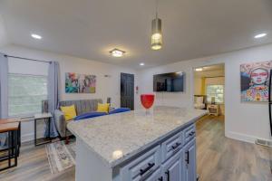 a kitchen with a counter top and a living room at Trim 1B 1BA in Gorgeous Columbia in Columbia