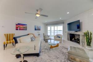 a living room with a couch and a tv at Modern Villa - Lake Views in Lake Murray Shores