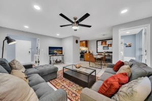 a living room with a couch and a ceiling fan at Beautiful space in Heart of Downtown ATL (Atlanta) in Atlanta