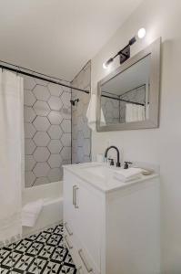 a white bathroom with a sink and a mirror at Quaint 1 BR Apt Min from USC in Columbia