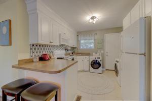 a kitchen with white cabinets and a white refrigerator at Comfy and Convenient Condo in Columbia +7 photos