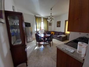 a kitchen and living room with a table and a couch at la casa di sotto in Alpignano