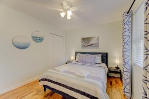 a white bedroom with a bed and a ceiling fan at Modern Renovated Apartment in Columbia