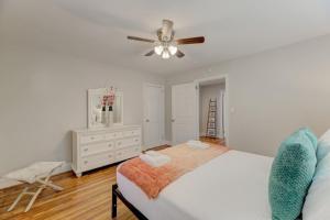 a white bedroom with a bed and a ceiling fan at Carolina Crash Pad Downstairs in Columbia