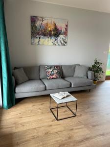 a living room with a couch and a table at MARS HOME in Kołobrzeg