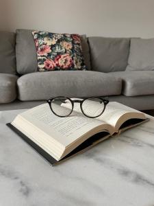 a book with a pair of glasses sitting on a table at MARS HOME in Kołobrzeg