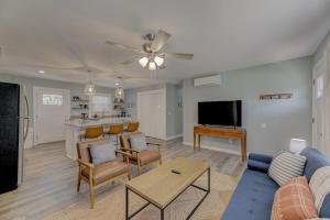 a living room with a blue couch and a table at Ft. Jackson Family Abode in Columbia