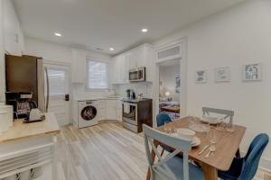a kitchen and dining room with a table and chairs at The Douglas Apartment in Columbia