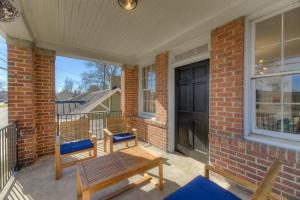 a porch with two benches and a black door at The Jewel of Bull St. Upstairs in Columbia