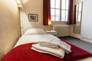 a hotel room with towels on a bed at Tagungs und Gästehaus St Georg in Cologne
