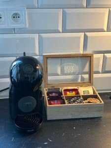a black toaster next to a box of cookies at New apartment 2 - self check in, free parking in Bratislava