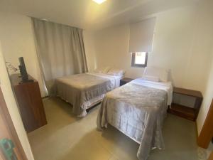 a hotel room with two beds and a television at Vila beija-flor prime / apt 02 in Mucugê +24 photos