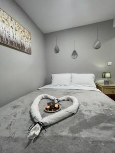 a bedroom with a bed with a bowl of food on it at Meraki house of kalymnos Apartments in Kalymnos