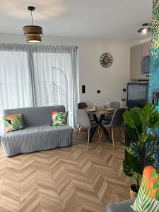 a living room with a couch and a table at Apartament Holiday Mini Gold in Rewal