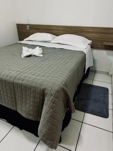 Säng eller sängar i ett rum på PORTAL PARQUE HOTEL