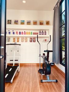 a gym with a treadmill and a exercise bike at Clubhouse Mark in Ban Kham Bon