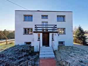 a white house with a door and stairs in front at Noclegi Kielce - Dom nad rzeką - pokoje in Kielce