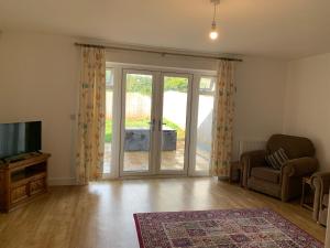 an empty living room with a sliding glass door at The Chestnuts in Winscombe