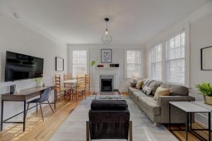 a living room with a couch and a table at Spacious Industrial Modern Apt in Columbia