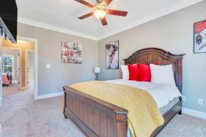 a bedroom with a large bed with red pillows at Lake Carolina Harborside Condo in Columbia