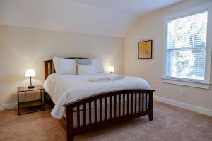 a bedroom with a large bed and a window at The Garnet Door Bungalow in Columbia