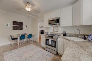 a kitchen with white cabinets and a table with chairs at Walk Cottontown Cozy Casa in Columbia