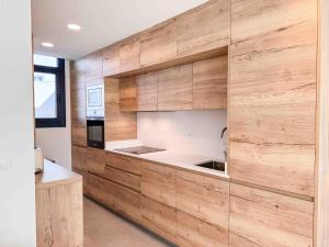 a kitchen with a large wooden wall at Tarifa Cozy House - La Tramontana in Tarifa