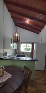 a kitchen with a table and a chair in it at CASA de bonito in Bonito