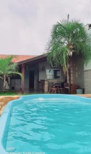 a large blue swimming pool in front of a house at CASA de bonito in Bonito