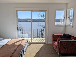 a bedroom with a bed and a view of the water at Hudson River Cliff House in Saugerties