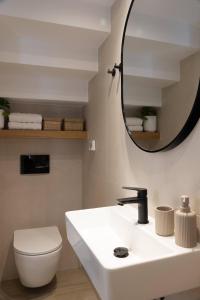 a bathroom with a white sink and a mirror at Paradise Villas in Sami +62 photos