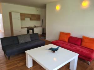 a living room with two couches and a table at GardenLoft no4 - enjoy in Vienna