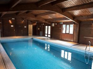 a large swimming pool in a wooden house at Eldroth in Skipton
