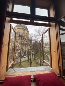 a large window with a view of a building at Apartments XVII Century in Lviv
