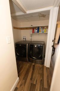 a laundry room with a washer and dryer in it at Astonishing 3-Bed Apt Close to NYC in Jersey City