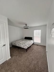 a bedroom with a bed in the corner of a room at The Getaway House ATL in Carrollton