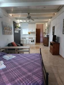 a bedroom with a purple bed and a living room at Iacovino Country House in Sarzana