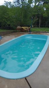 a large blue swimming pool with a playground at Alojamiento Los Amigos in Vaqueros