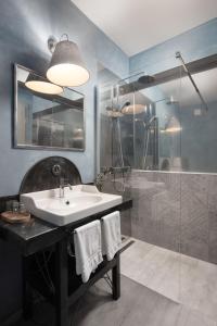 a bathroom with a sink and a shower at Mirakul Residence in Labin