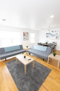a living room with two beds and a table at Astonishing 3-Bed Apt Close to NYC in Jersey City