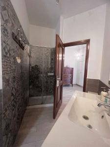 a bathroom with a shower and a white sink at Enjoy in Lido di Ostia