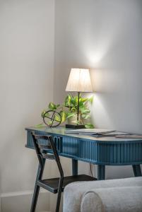 a desk with a lamp and a chair at Charming Retreat - Close to Zoo and Downtown in Omaha
