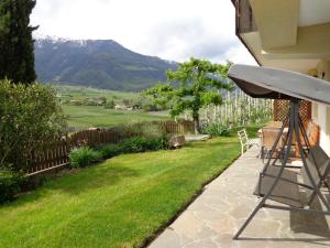 a view from the backyard of a house with a green lawn at Haus Talblick "Envy" Ferienwohnung in Naturno +14 photos