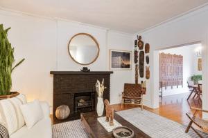 a living room with a fireplace and a mirror at Exquisite Luxury Estate - Steps to Downtown in Toronto