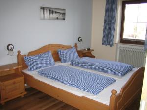 a bedroom with two beds with blue and white pillows at Bergschlössl - Erdgeschosswohnung Hunde sind Willkommen in Oberaudorf