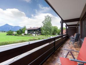 a balcony with a view of a house at Moderne Bergstube mit 2 Schlafzimmer und großen Balkon in Oberaudorf