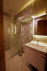 La salle de bains est pourvue d'un lavabo et d'une douche. dans l'établissement Sarok Hotel, à Duhok