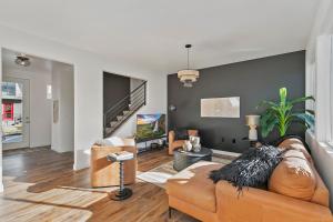 a living room with a couch and a tv at Coopers North in Old Town - Hot Tub & Pool Table! in Fort Collins +68 photos