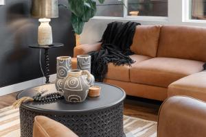 a living room with a couch and a table at Coopers North in Old Town - Hot Tub & Pool Table! in Fort Collins
